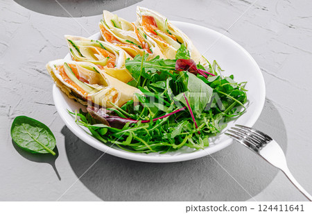 Fresh wrap rolls with salad served on a gray table 124411641