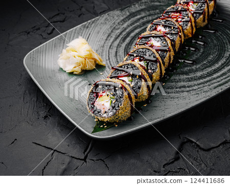 Delicious sushi roll with unique toppings on elegant plate 124411686