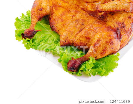 Roasted chicken on fresh lettuce isolated on white Roasted chicken on fresh lettuce isolated on white 124411689