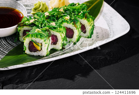 Fresh tuna sushi roll with seaweed salad Fresh tuna sushi roll with seaweed salad 124411696
