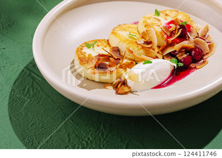 Delicious dessert with pancakes, cream, and berries served elegantly 124411746