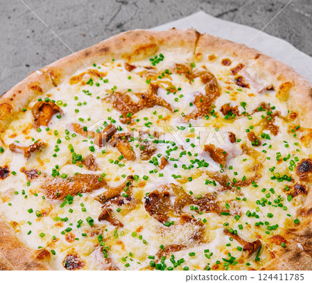 Freshly baked gourmet pizza on wooden board 124411785