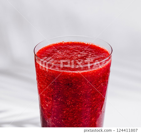 Glass of refreshing cold strawberry smoothie on white background Glass of refreshing cold strawberry smoothie on white background 124411807
