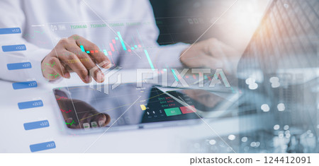 Investors using laptop to analyze stock market, Investment strategies, Business growth analysis, Companies with long term competitive advantage, With city backdrop. Investors using laptop to analyze stock market, Investment strategies, Business growth analysis, Companies with long term competitive advantage, With city backdrop. 124412091