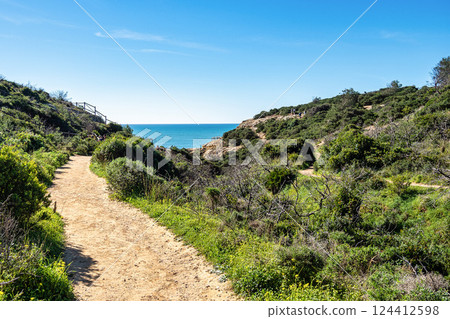 Praia da Marinha Beach among rock islets and cliffs seen from Seven Hanging Valleys Trail, Algarve, Portugal Praia da Marinha Beach among rock islets and cliffs seen from Seven Hanging Valleys Trail, Algarve, Portugal 124412598