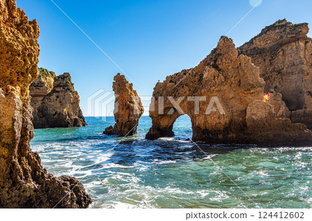 Ponta da Piedade is a unique rock formation with famous grottos in the ocean at Lagos, Algrave, Portugal 124412602