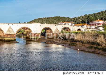 The Roman bridge, Ponte Romana in the city of Silves in the Algarve region of Portugal. The Roman bridge, Ponte Romana in the city of Silves in the Algarve region of Portugal. 124412611