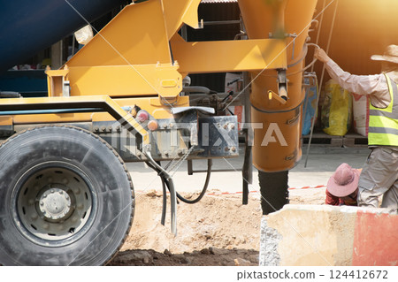 Engineers are overseeing the pouring of concrete. 124412672