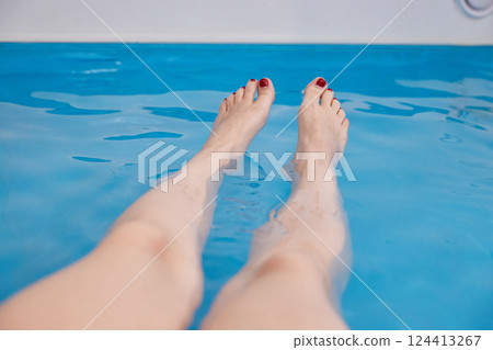 Women's feet in a saltwater pool. Water spa treatments in the sanatorium. Women's feet in a saltwater pool. Water spa treatments in the sanatorium. 124413267