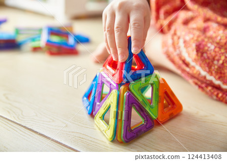 Close-up of a triangle from a children's magnetic color constructor 124413408