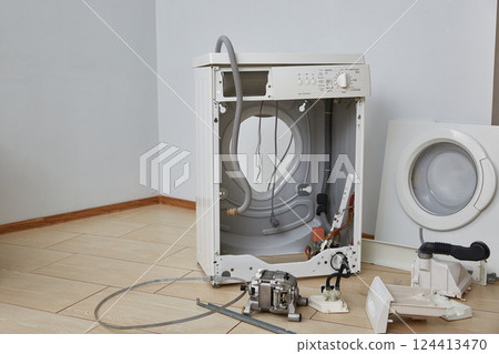 Washing machine repair. Disassembled washing machine Washing machine repair. Disassembled washing machine 124413470