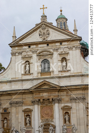 Baroque Facade of a Historic Church with Sculptures and Cross 124413777