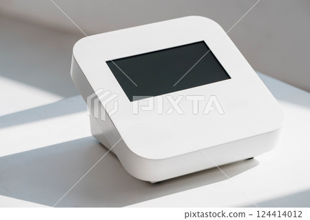 Modern Minimalist Compact Payment Terminal with Sleek White Design and Digital Screen Display Modern Minimalist Compact Payment Terminal with Sleek White Design and Digital Screen Display 124414012