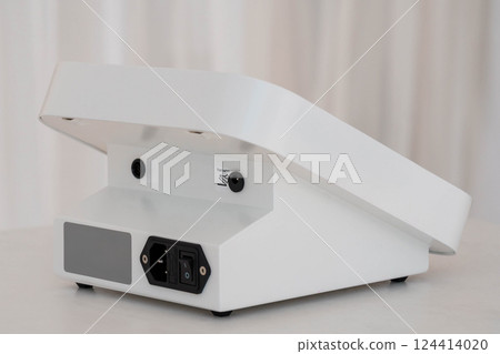 Modern Compact Electronic Device in White Housing with Power Input and Minimalist Design 124414020