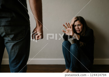 Woman in fear facing domestic violence situation indoors 124414794