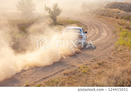 White Car Drives away in a Cloud of Dust 124415031