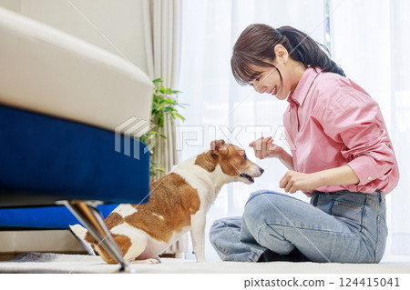 Woman giving a treat to a dog 124415041