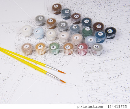 A set of colorful gouache paints, brushes and canvas with numbers is ready for drawing education. Hobby and leisure activity. Background with copy space A set of colorful gouache paints, brushes and canvas with numbers is ready for drawing education. Hobby and leisure activity. Background with copy space 124415755