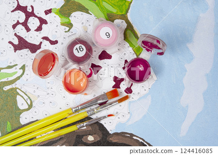 Painting by numbers. Set to paint the picture, includes a canvas, paints of different colors, brushes. Top view. 124416085