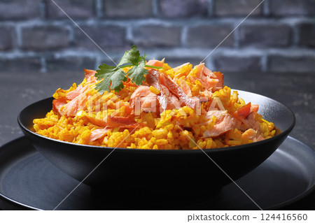 hot smoked salmon kedgeree in a black bowl 124416560