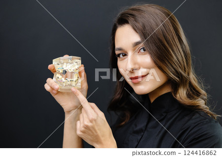 Orthopedic dentist doctor is holding teeth 3d printed model of the patient's jaw with malocclusion 124416862