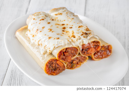 Oven-Baked Cannelloni Stuffed with Savory Bolognese and Covered in Golden Mozzarella 124417074