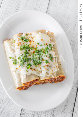 Oven-Baked Cannelloni Stuffed with Savory Bolognese and Covered in Golden Mozzarella Oven-Baked Cannelloni Stuffed with Savory Bolognese and Covered in Golden Mozzarella 124417075