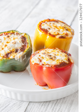 Juicy Baked Bell Peppers Stuffed with Flavorful Bolognese and Topped with Golden Mozzarella 124417077