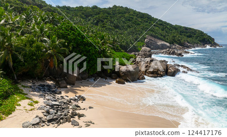 Tropical beach with clear turquoise water and rocky outcrops. Seychelles, Mahe. Anse Boileau. 124417176