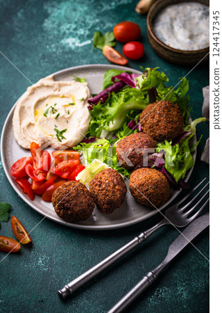 Salad with hummus, falafel and vegetables 124417345