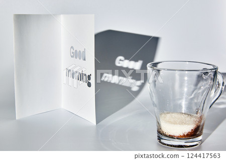 A cup of instant coffee and sugar and a good morning greeting card. table. 124417563