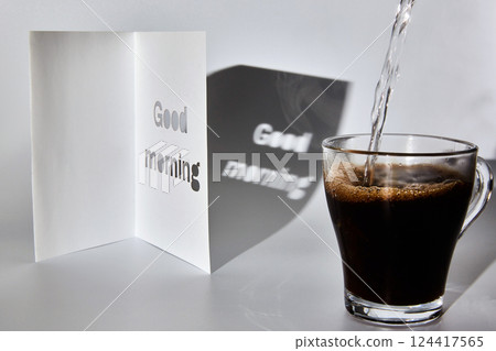 A cup of coffee and a good morning card A cup of coffee and a good morning card 124417565