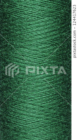 macro texture of a skein of green sewing thread 124417623
