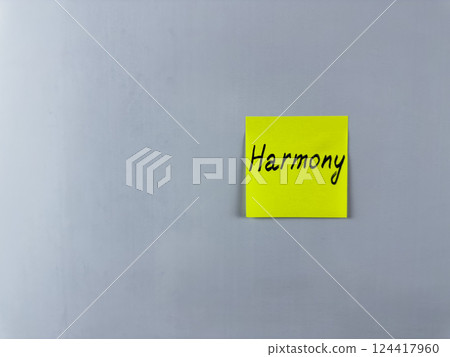 Sticky note with the word Harmony written on it, placed on white background. Ideal for illustrating harmony, balance, and unity in life and relationships. Perfect for concept creation 124417960