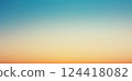 Soft pastel gradient with warm sunlight hues blending into blue sky 124418082