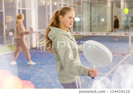 Girl tennis player playing padel tennis 124419110