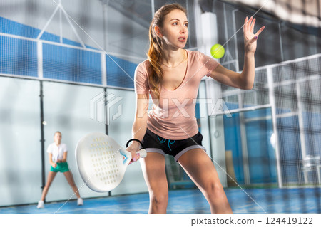 Portrait of a young woman playing padel 124419122