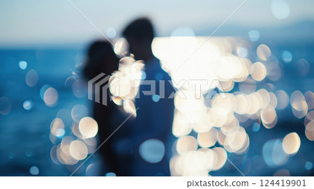 Blurry images of a couple saying I do with the ocean in the background at their beach nuptials 124419901