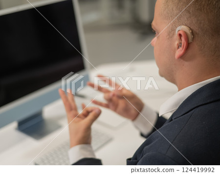 Caucasian deaf man uses sign language for online negotiations. Caucasian deaf man uses sign language for online negotiations. 124419992