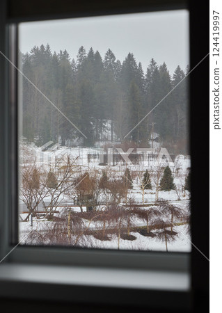 A beautiful winter landscape visible through a window, inviting exploration and adventure 124419997
