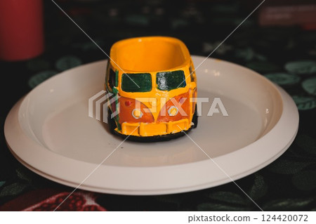 A Vibrant and Colorful Miniature VW Bus Displayed on a Decorative Plate for Aesthetic Appeal A Vibrant and Colorful Miniature VW Bus Displayed on a Decorative Plate for Aesthetic Appeal 124420072
