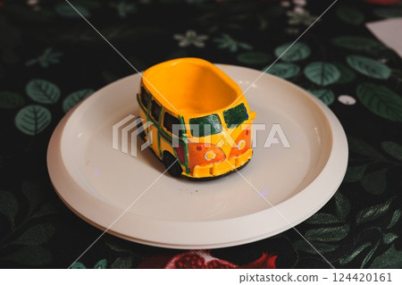A Beautiful and Colorful Vintage Car Bowl, Artfully Presented on a Stylish Decorative Plate A Beautiful and Colorful Vintage Car Bowl, Artfully Presented on a Stylish Decorative Plate 124420161