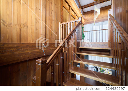 An Elegant Wooden Staircase Bathed in Beautiful Natural Light Creates a Warm Atmosphere An Elegant Wooden Staircase Bathed in Beautiful Natural Light Creates a Warm Atmosphere 124420297