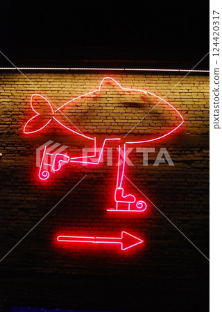 Bright and colorful Neon Fish Sign featuring an Arrow Direction for your attraction needs 124420317