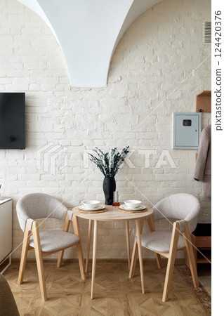 This Stylish Dining Space features a Minimalist Design that emphasizes clean lines and elegance 124420376