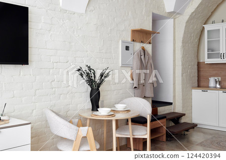 A Modern Minimalist Kitchen and Dining Area that features Cozy Decor and Elegant Touches 124420394