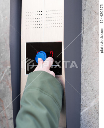 Person entering security code on keypad access control system. 124420873