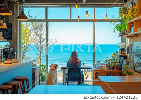 A woman and her dog enjoying a peaceful moment looking out at the blue sea from a cafe A woman and her dog enjoying a peaceful moment looking out at the blue sea from a cafe 124421126