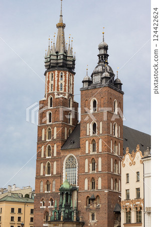 Historical church towers in Krakow captured in clear daylight. The medieval architecture Historical church towers in Krakow captured in clear daylight. The medieval architecture 124422624