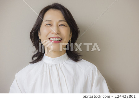 Middle-aged woman in a white shirt Middle-aged woman in a white shirt 124422801